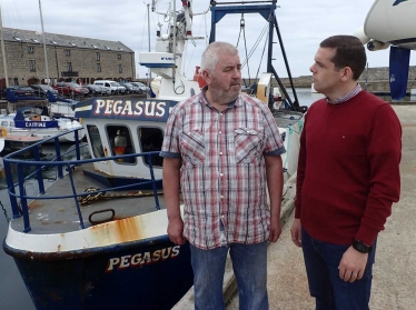 Douglas Ross MP with Douglas Scott, fisherman at his boat in Lossiemouth