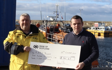 Douglas hands cheque to RNLI