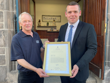 Douglas presents framed image of his Parliamentary motion to the Street Pastors