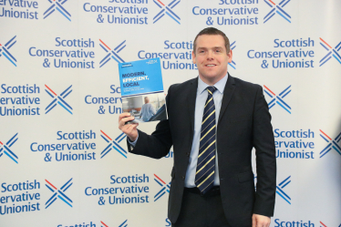 Douglas holds policy booklet