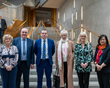 Douglas stands in Parliament with Save our Surgeries campaigners